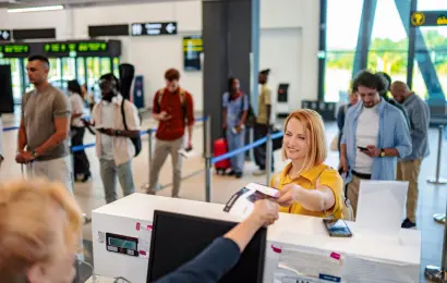 Passengers waiting in line at an airport departure gate