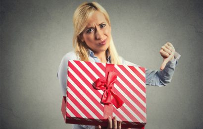 Woman opening a gift she doesn't like