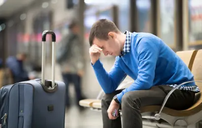 Frustrated traveler waiting at an airport after a flight problem
