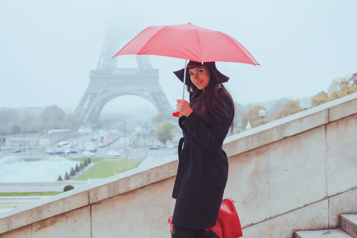 Woman with red umbrella in rainy Paris