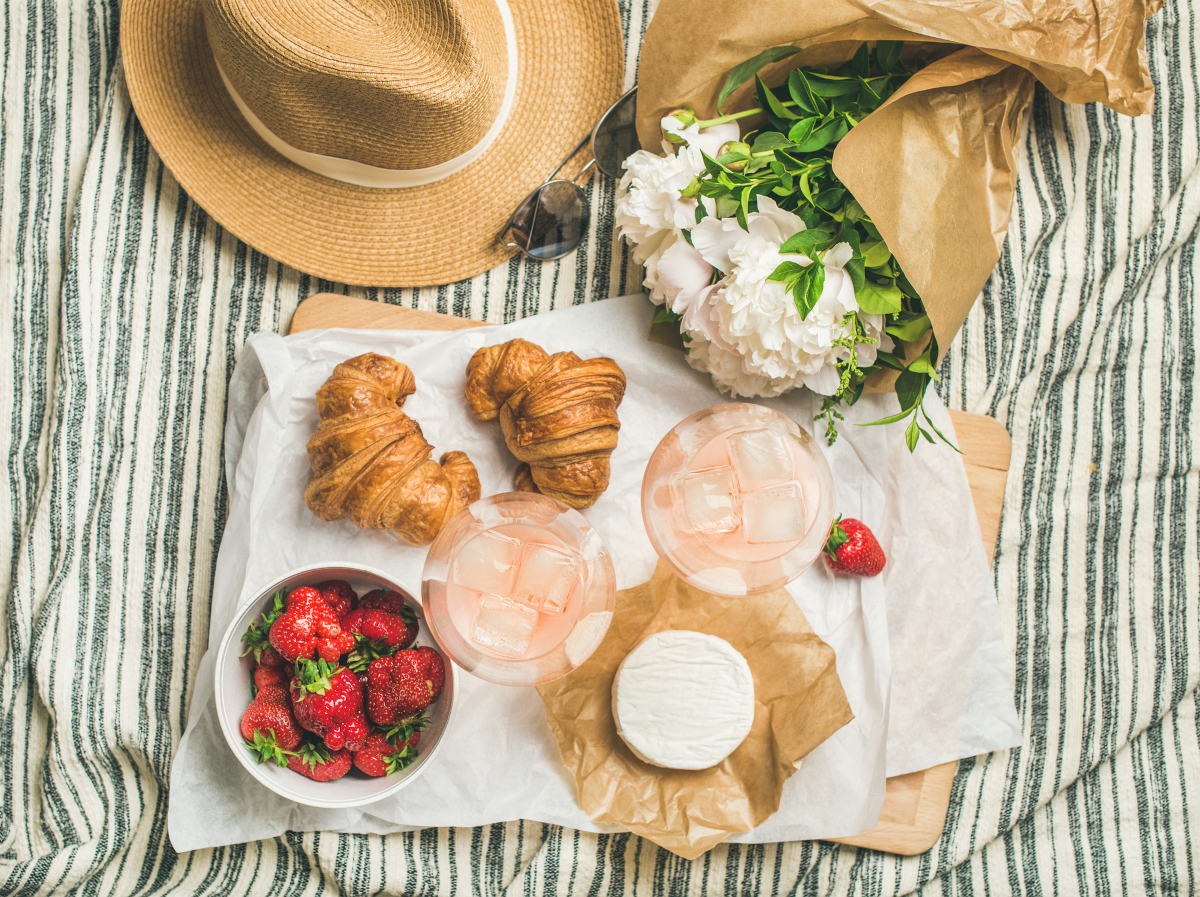 Rosé wine with croissants Brie cheese and strawberries