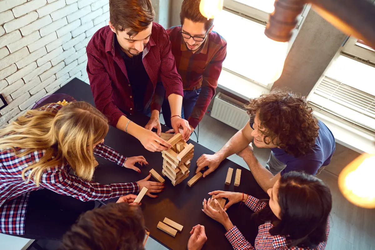 Overhead view of friends playing board games together indoors