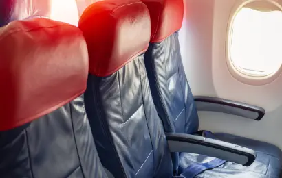 Empty economy class seats beside an airplane window