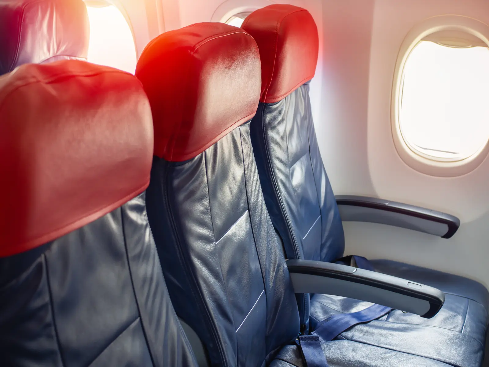 Empty economy class seats beside an airplane window