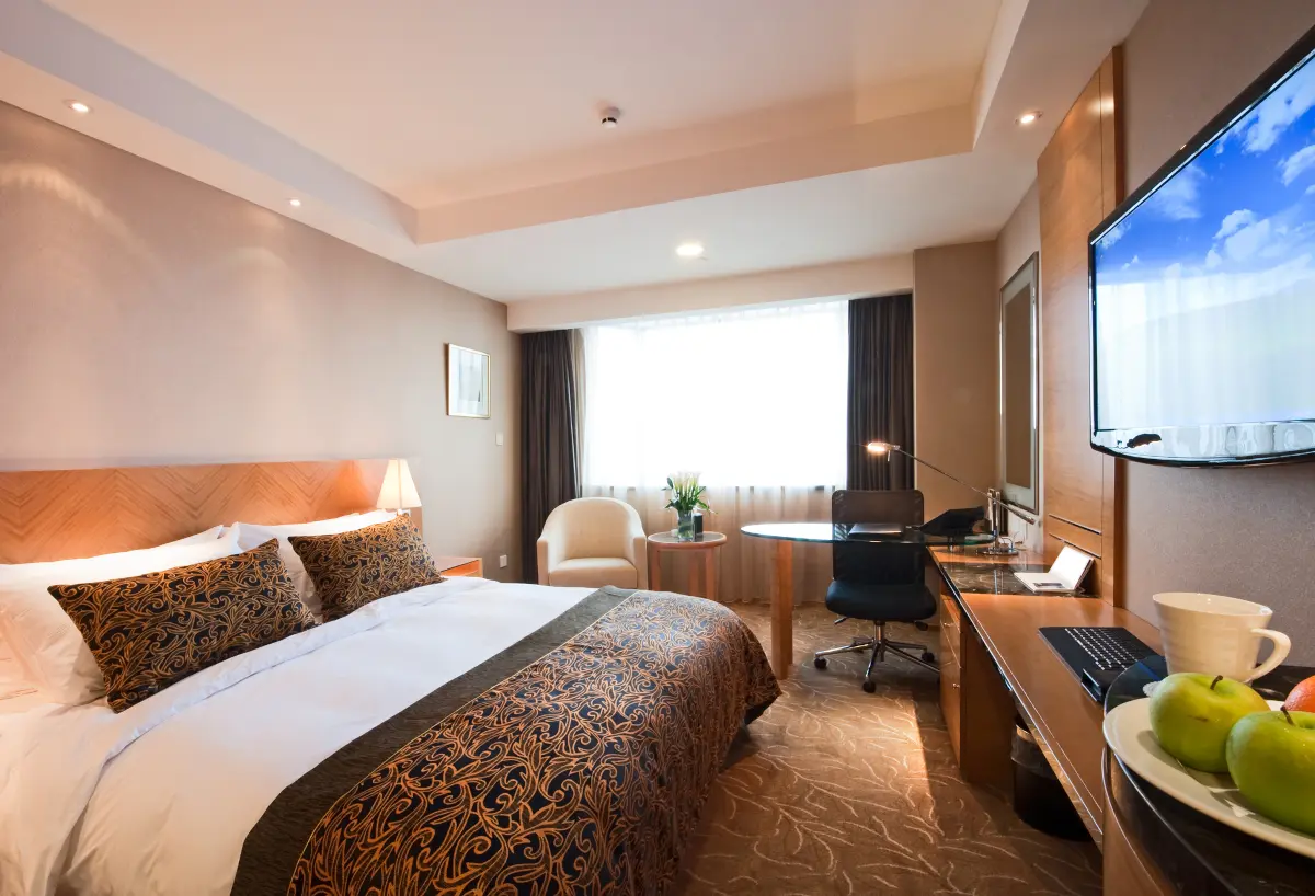 Elegant deluxe hotel room interior with a large bed and comfortable furnishings