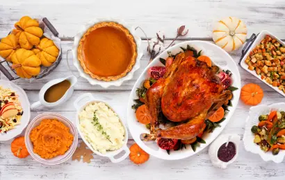 Thanksgiving dinner with roasted turkey, mashed potatoes, stuffing, pumpkin pie and traditional side dishes