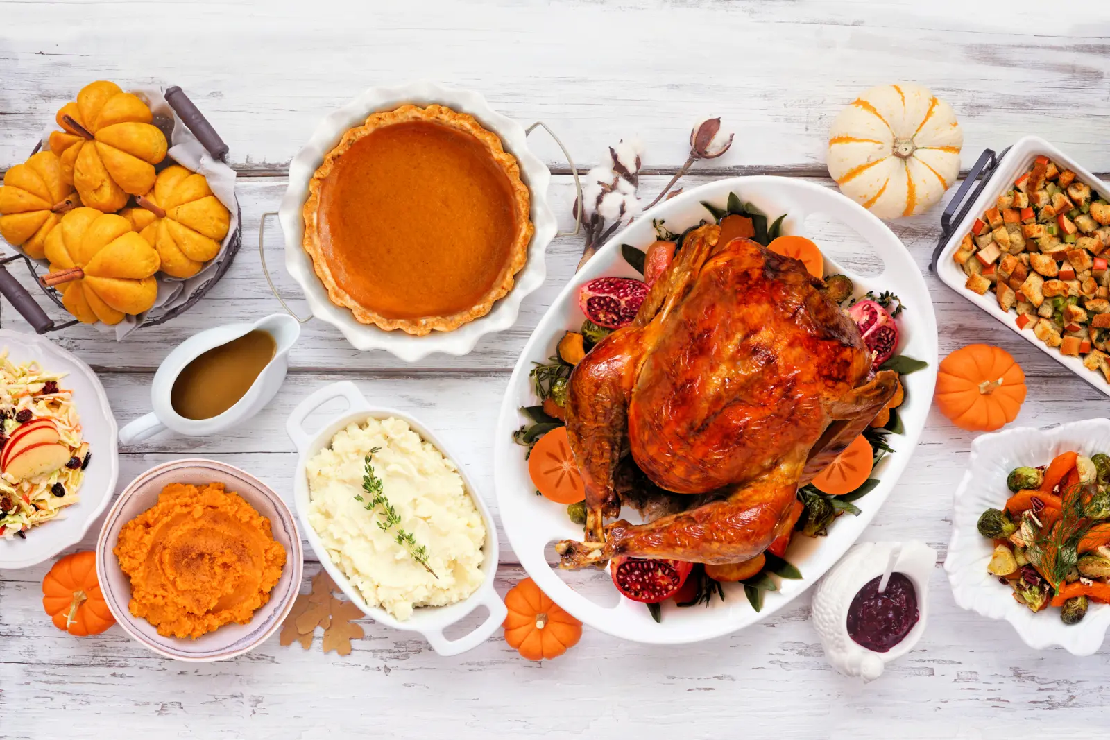 Thanksgiving dinner with roasted turkey, mashed potatoes, stuffing, pumpkin pie and traditional side dishes