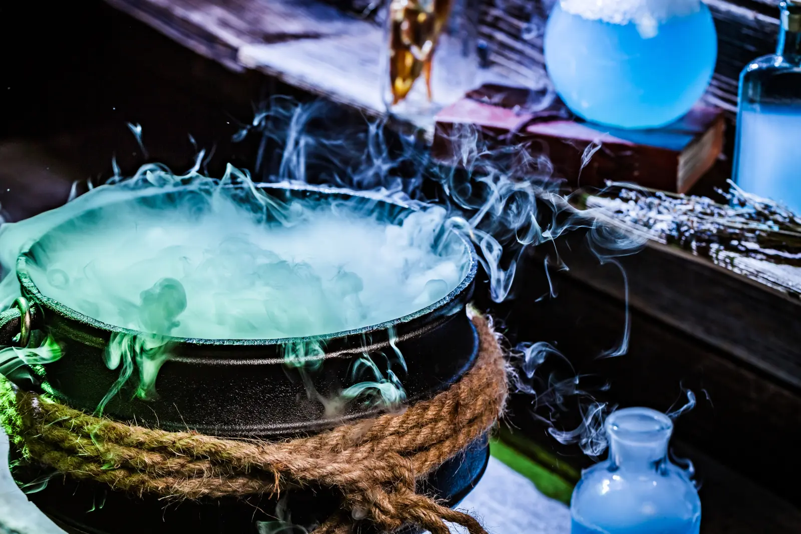 Witch's cauldron with blue magical potion for a Hocus Pocus trivia quiz about the 1993 movie